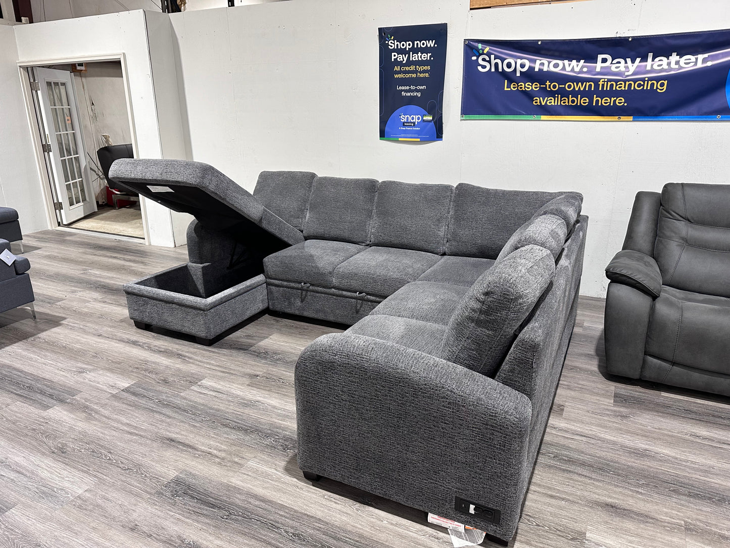Navy Gray Sectional couch with storage compartment and pull out bed