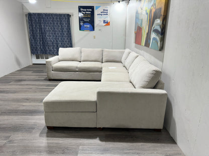 Three-piece beige sectional with storage Chase