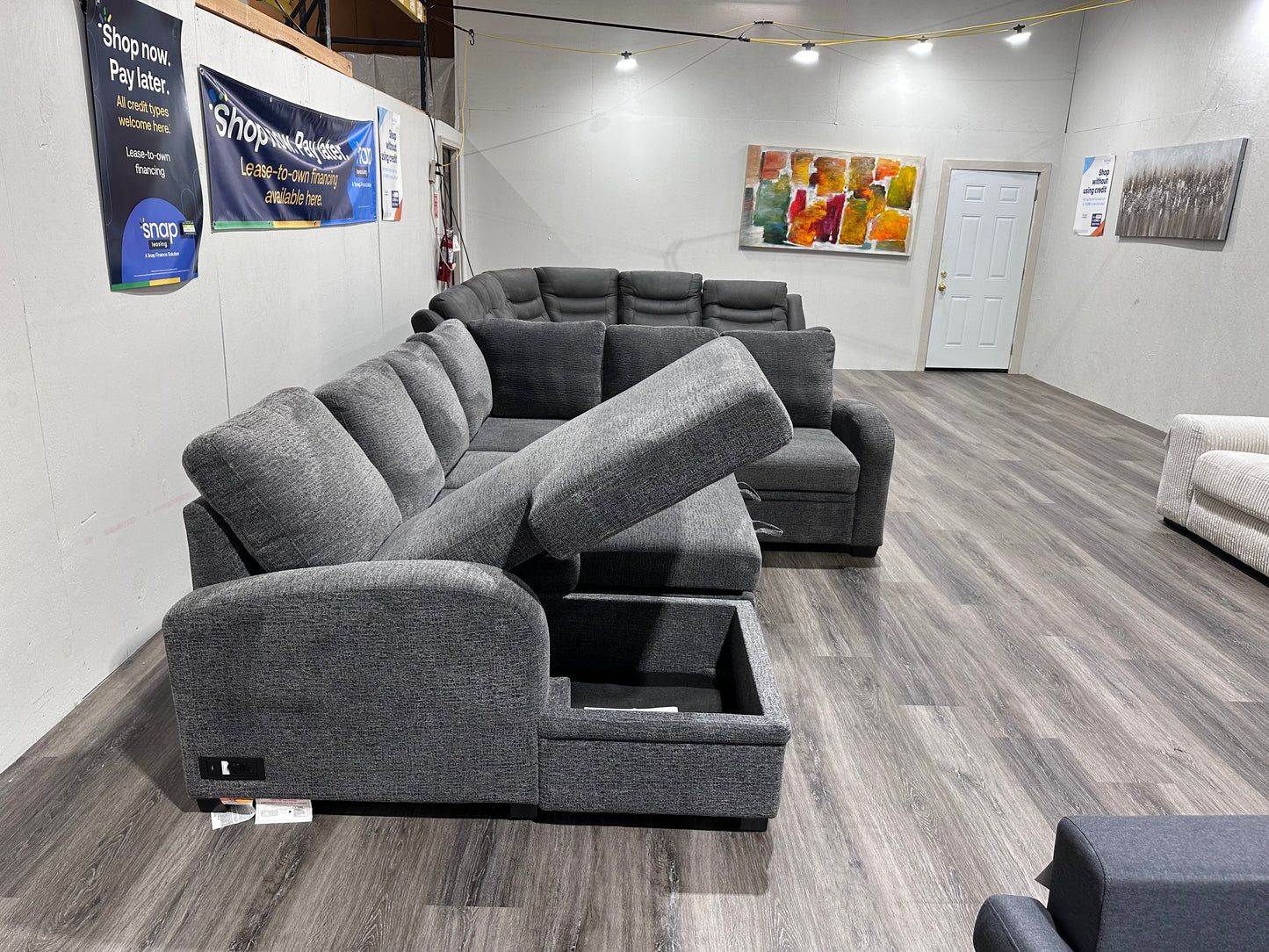 Navy Gray Sectional couch with storage compartment and pull out bed